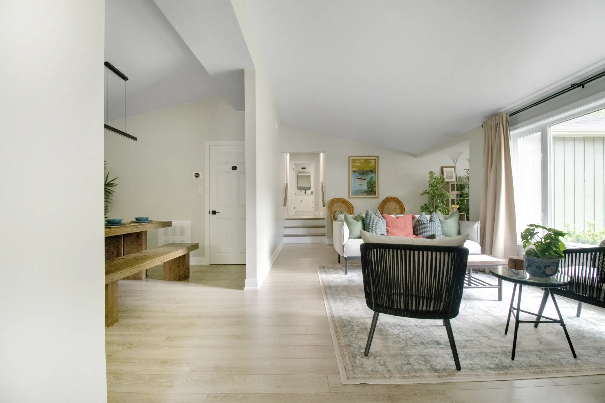 The open living space looking through to the hallway, with a long bench
